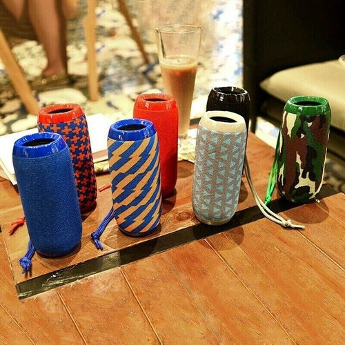 Bluetooth Speaker Wireless Waterproof Outdoor Stereo Bass USB/TF/FM in vibrant colors displayed on a wooden table.