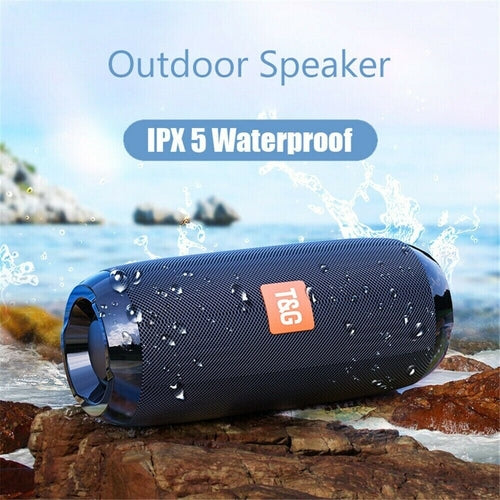 Bluetooth Speaker Wireless Waterproof Outdoor Stereo Bass USB/TF/FM on outdoor rocks beside water.