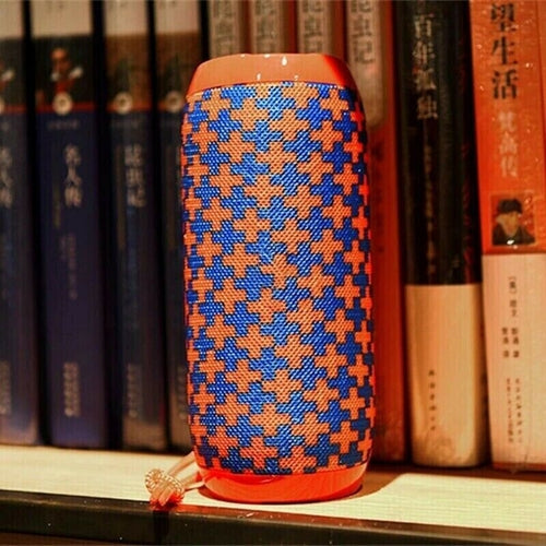 Bluetooth Speaker Wireless Waterproof Outdoor Stereo Bass USB/TF/FM on a shelf with books.