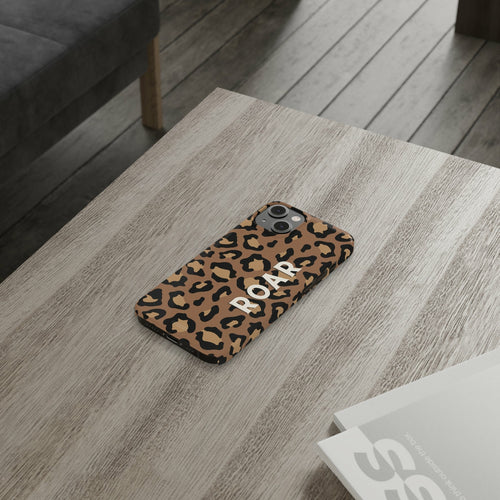 Leopard Print Slim Case for iPhone 14 Series on a wooden table showcasing its glossy finish.